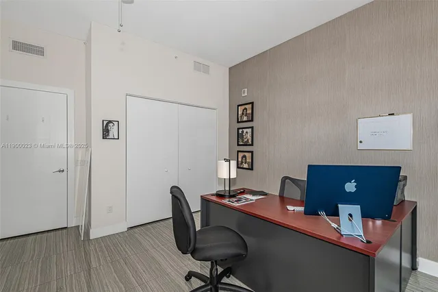 a view of a workspace with furniture and wooden floor