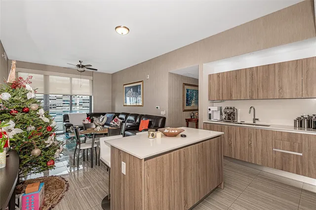 a view of a kitchen with furniture and a potted plant