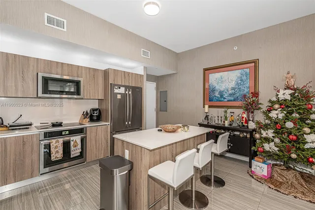 a kitchen with a stove a sink a dining table and chairs