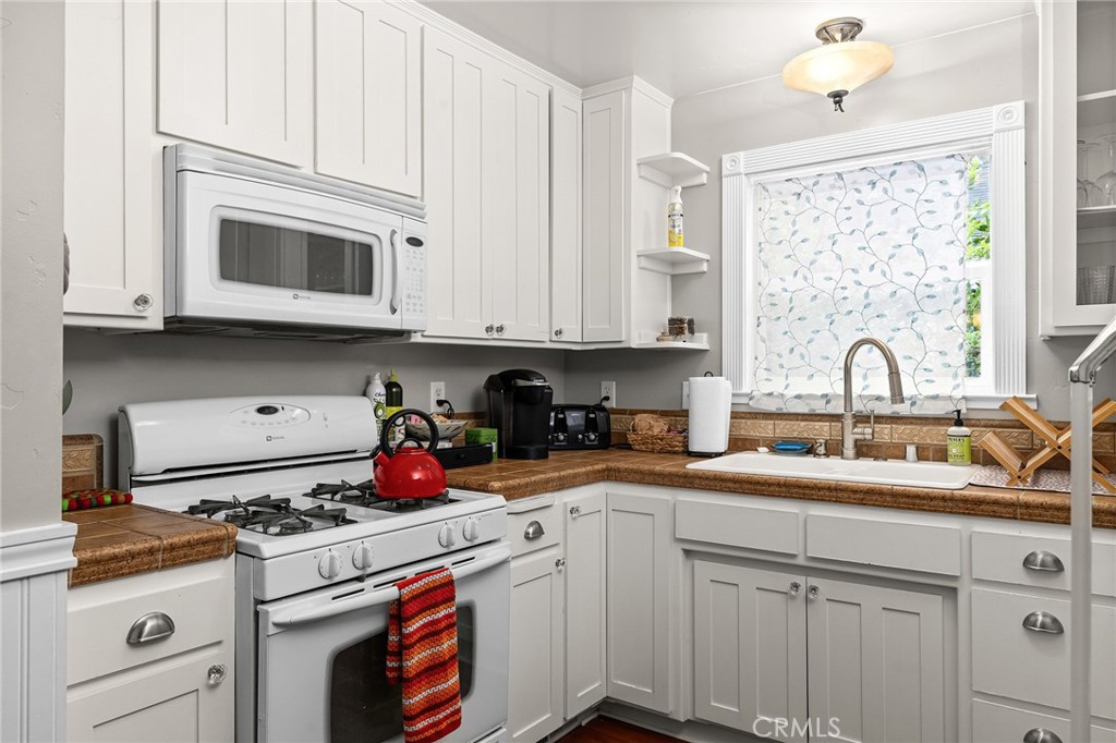 740 Orient Street Chico, CA 95928 - Photo 19 of 48 a kitchen with stainless steel appliances granite countertop a sink stove and cabinets