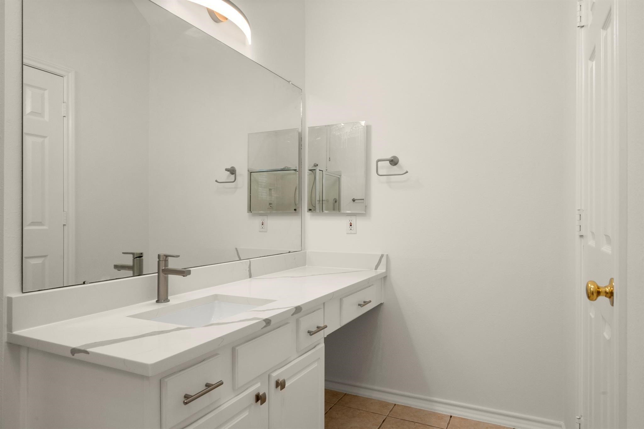 21014 Jessica Rose Lane Spring, TX 77379 - Photo 25 of 30 a bathroom with a sink and a mirror