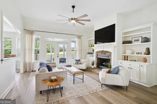 a living room with furniture a fireplace and a flat screen tv