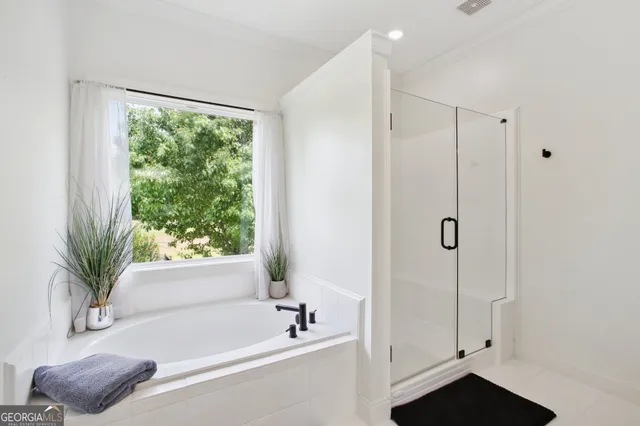 a bathroom with a bathtub and a shower