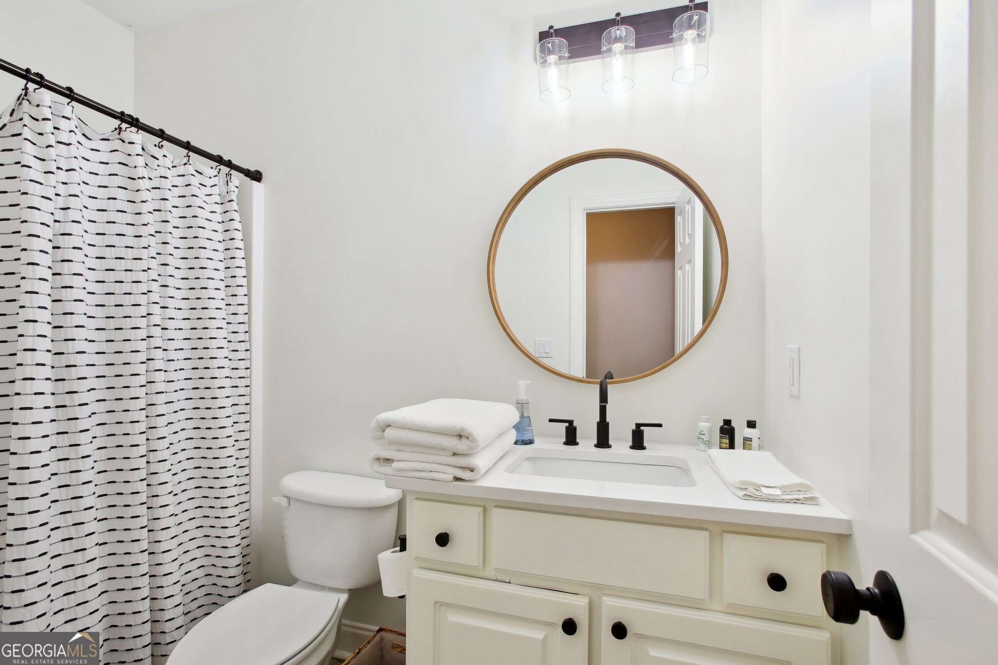 524 Forrest Avenue Fayetteville, GA 30214 - Photo 17 of 30 a bathroom with a sink a toilet and a mirror