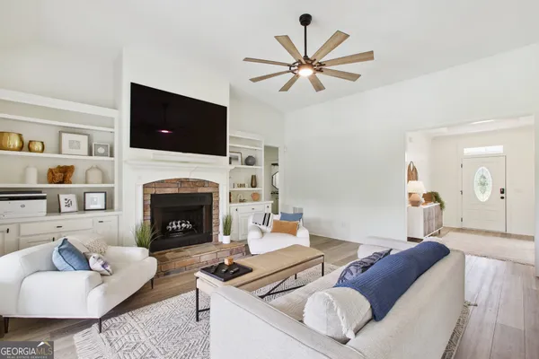 a living room with furniture and a fireplace