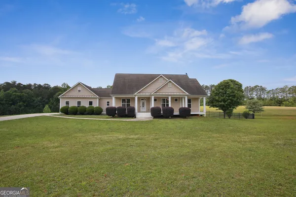 a front view of a house with garden