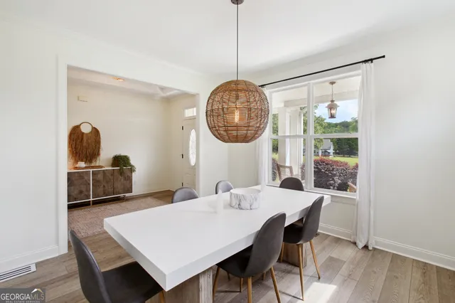 a view of a dining room with a table and chairs