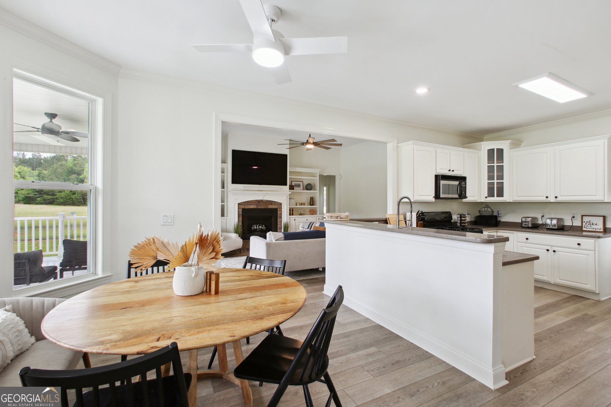 524 Forrest Avenue Fayetteville, GA 30214 - Photo 7 of 30 a kitchen with stainless steel appliances granite countertop a dining table and chairs