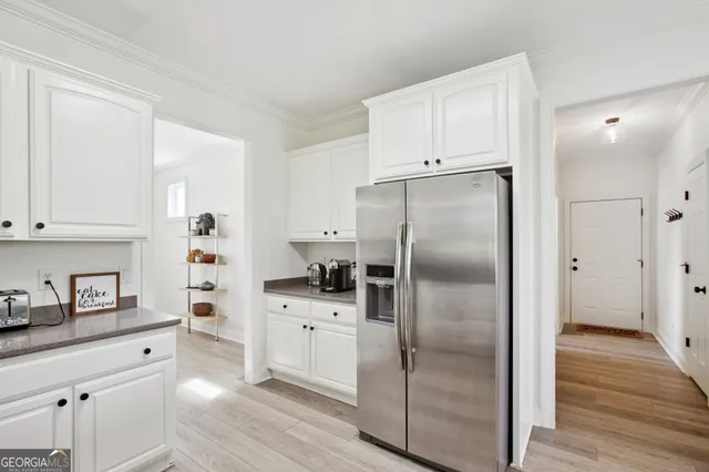 a kitchen with stainless steel appliances a refrigerator sink and cabinets