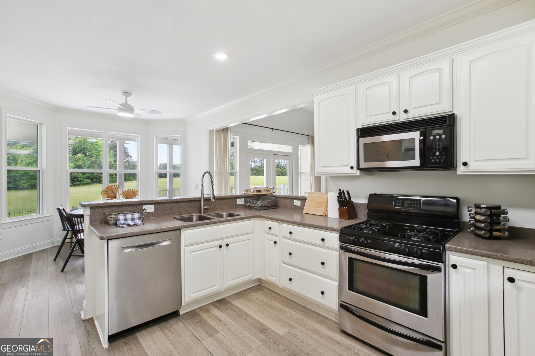 524 Forrest Avenue Fayetteville, GA 30214 - Photo 9 of 30 a kitchen with stainless steel appliances white cabinets and sink