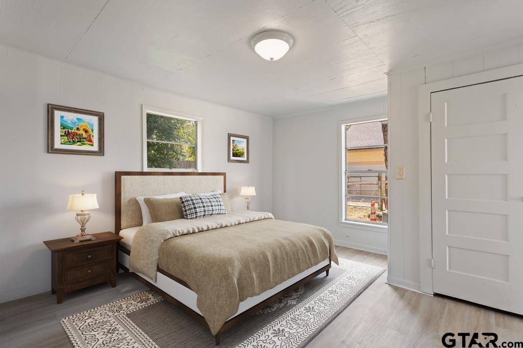 210 Cooper Street Lindale, TX 75771 - Photo 5 of 23 a bedroom with a large bed and a window