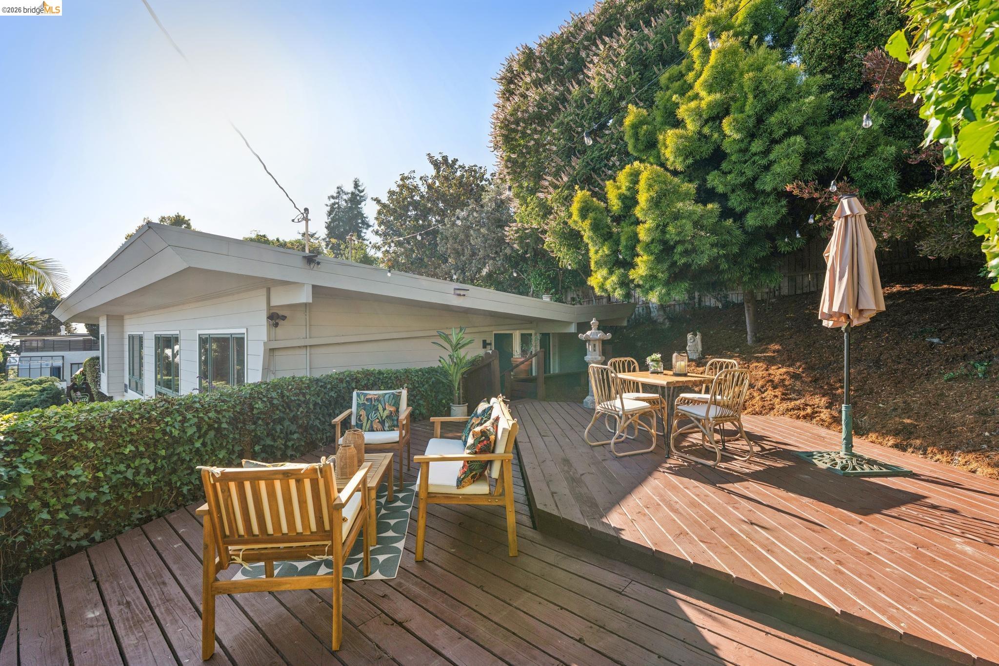 2301 Oak Street Berkeley, CA 94708 - Photo 44 of 61 Multi-level wood-finish deck with integrated landscaping, offering distinct areas for relaxation and dining