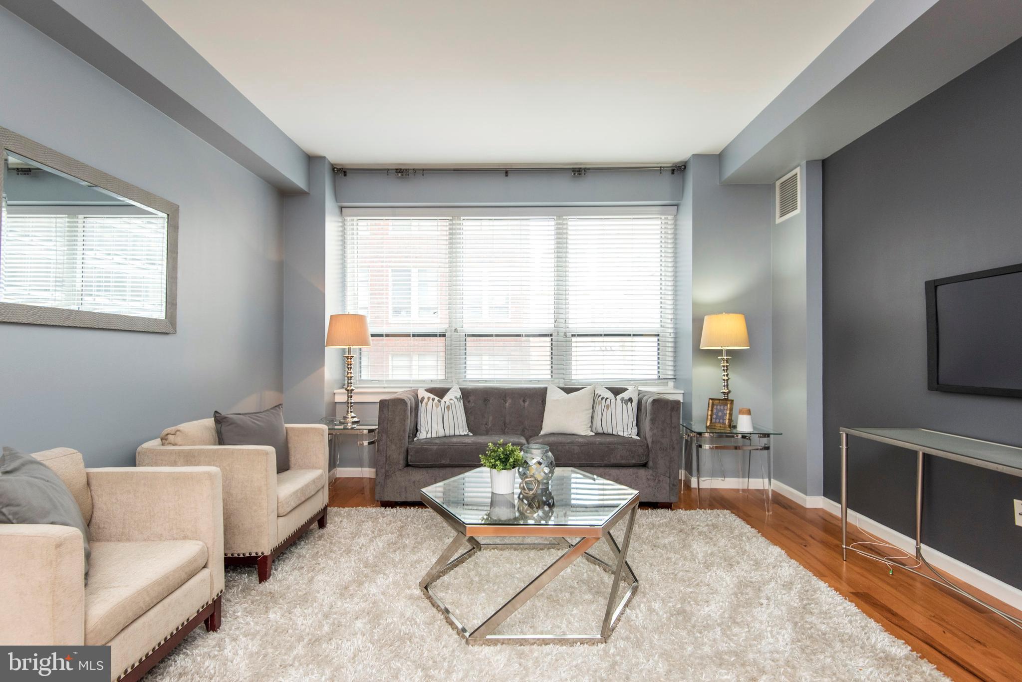 1425 Locust Street, Unit 4F Philadelphia, PA 19102 - Photo 2 of 34 a living room with furniture and a large window
