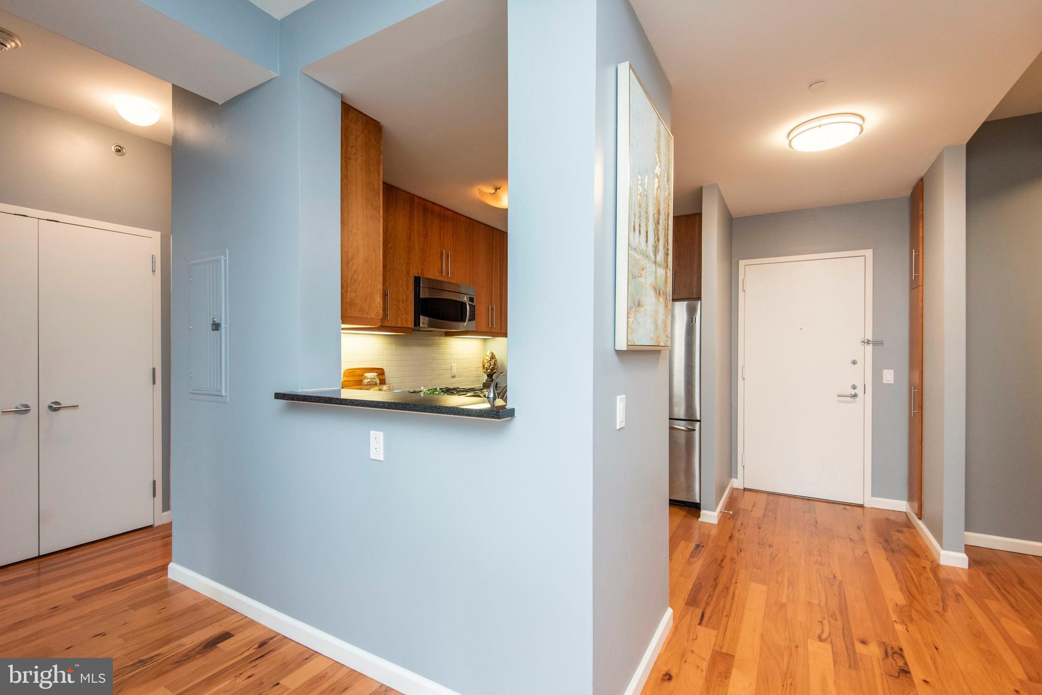 1425 Locust Street, Unit 4F Philadelphia, PA 19102 - Photo 16 of 34 a view of a bedroom with wooden floor and a bed