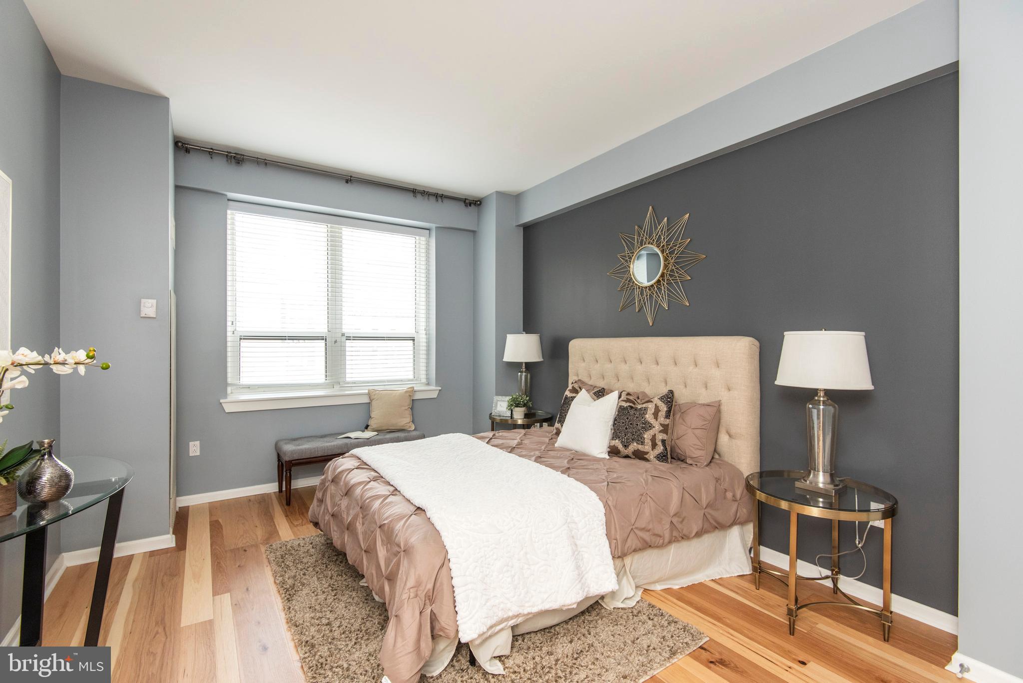 1425 Locust Street, Unit 4F Philadelphia, PA 19102 - Photo 19 of 34 a bedroom with a bed and wooden floor