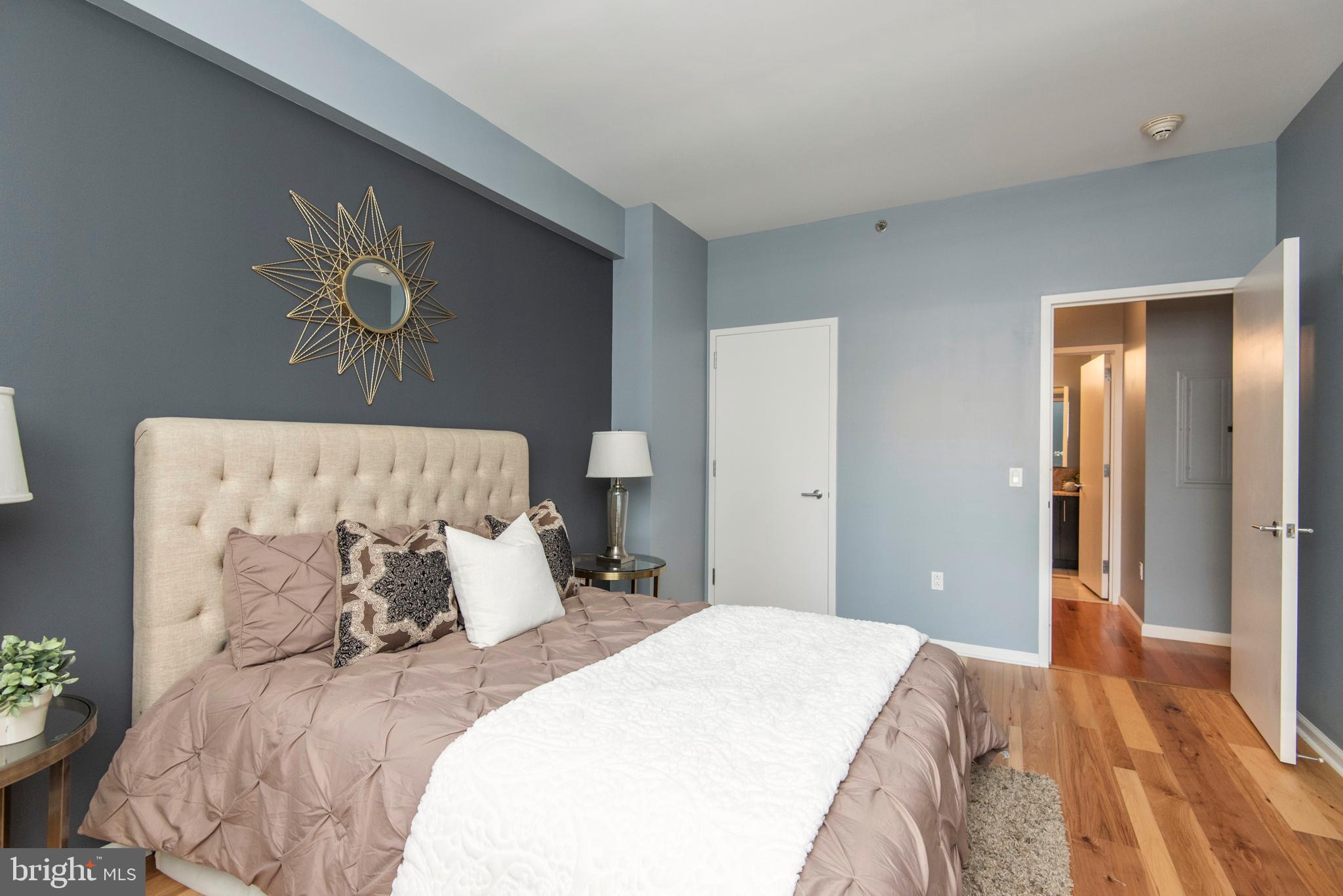 1425 Locust Street, Unit 4F Philadelphia, PA 19102 - Photo 21 of 34 a bedroom with a bed and a painting on the wall