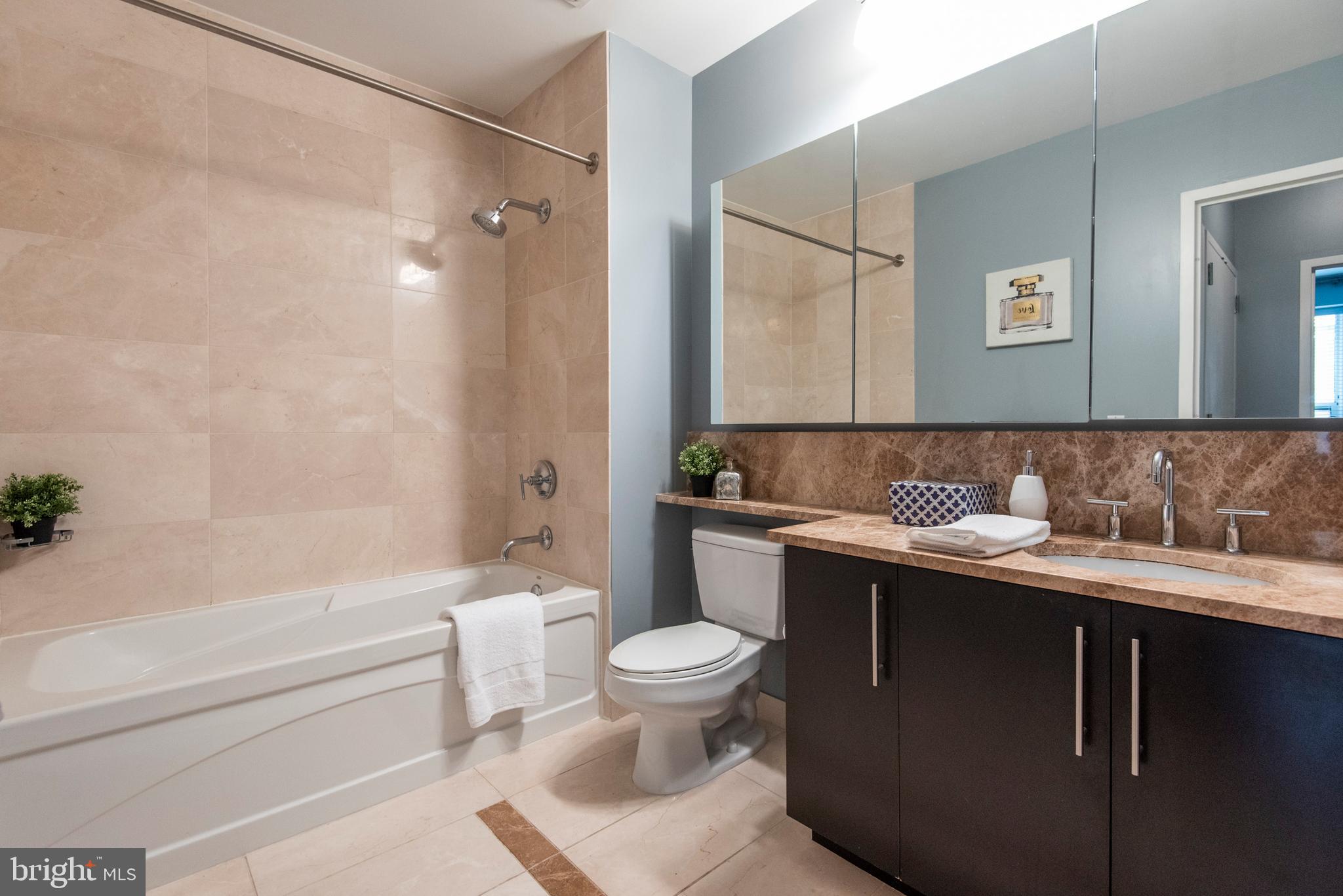 1425 Locust Street, Unit 4F Philadelphia, PA 19102 - Photo 23 of 34 a bathroom with a sink a toilet and a bathtub