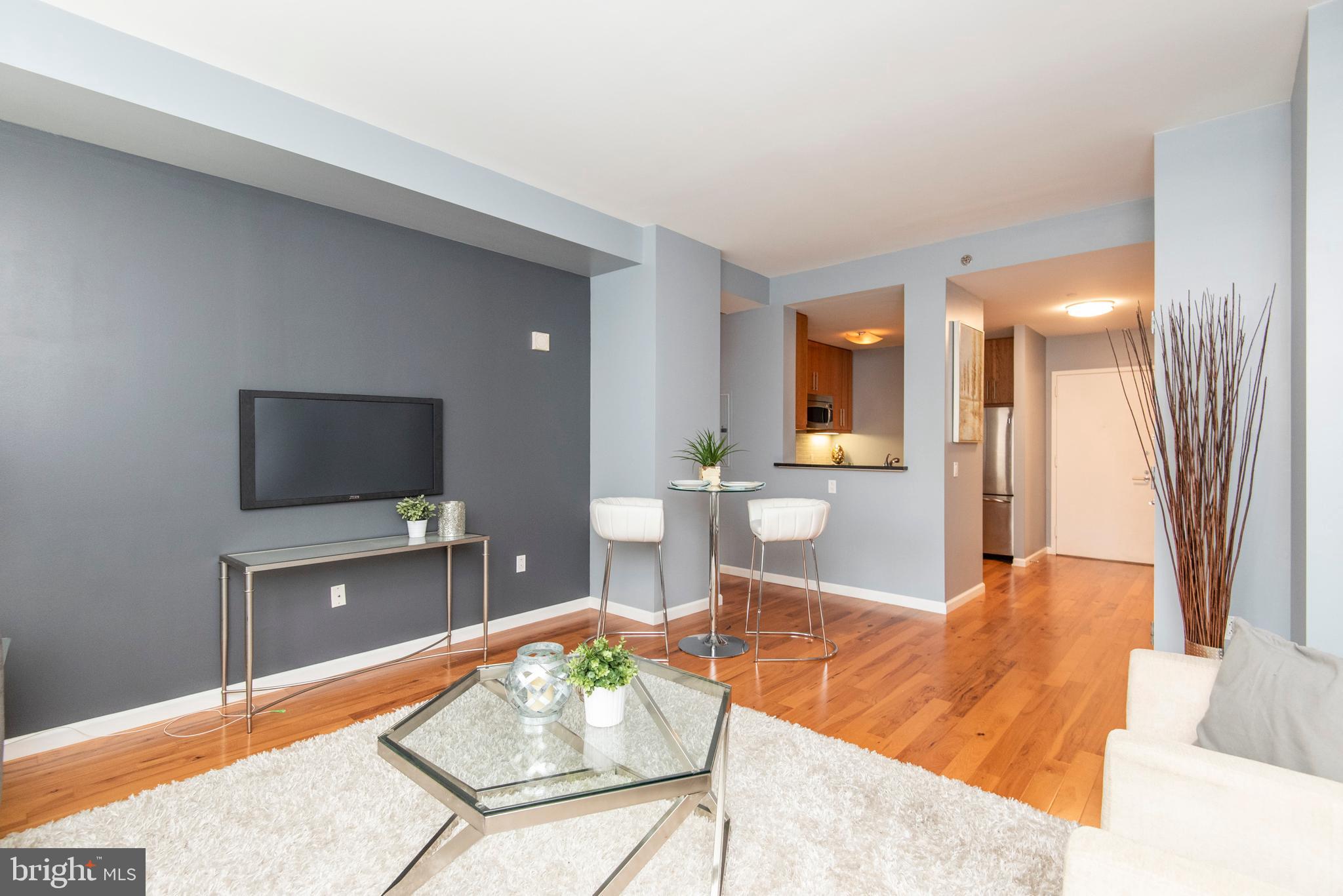 1425 Locust Street, Unit 4F Philadelphia, PA 19102 - Photo 4 of 34 a living room with furniture and a flat screen tv