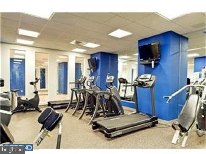 1425 Locust Street, Unit 4F Philadelphia, PA 19102 - Photo 32 of 34 a room with gym equipment and view of living room