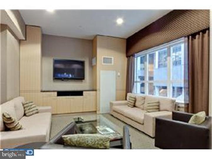 1425 Locust Street, Unit 4F Philadelphia, PA 19102 - Photo 33 of 34 a living room with furniture and a flat screen tv