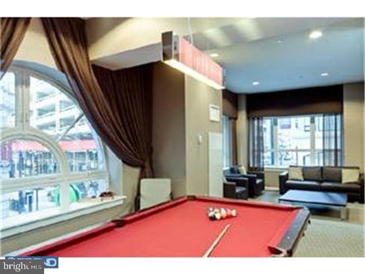 1425 Locust Street, Unit 4F Philadelphia, PA 19102 - Photo 34 of 34 a living room with furniture pool table and a large window