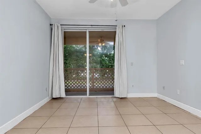 en empty room with sliding glass door and glass door