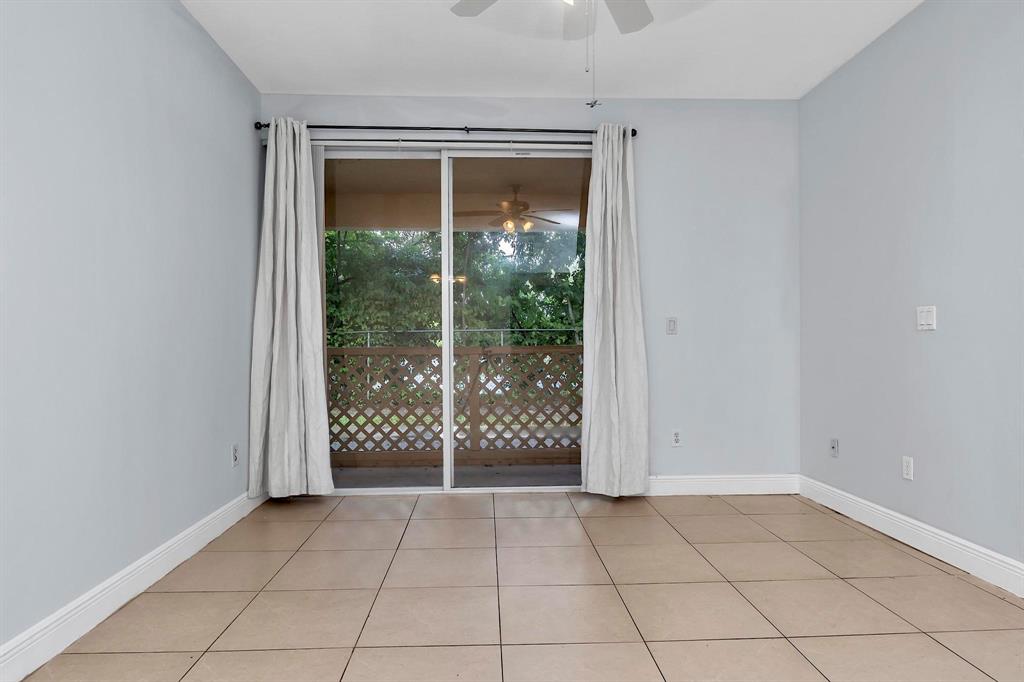 18352 Northwest 68th Avenue, Unit M Hialeah, FL 33015 - Photo 11 of 28 en empty room with sliding glass door and glass door