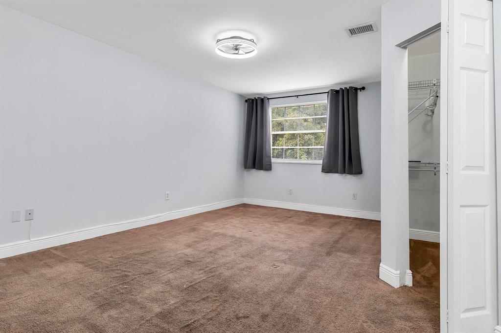 18352 Northwest 68th Avenue, Unit M Hialeah, FL 33015 - Photo 23 of 28 an empty room with windows and closet