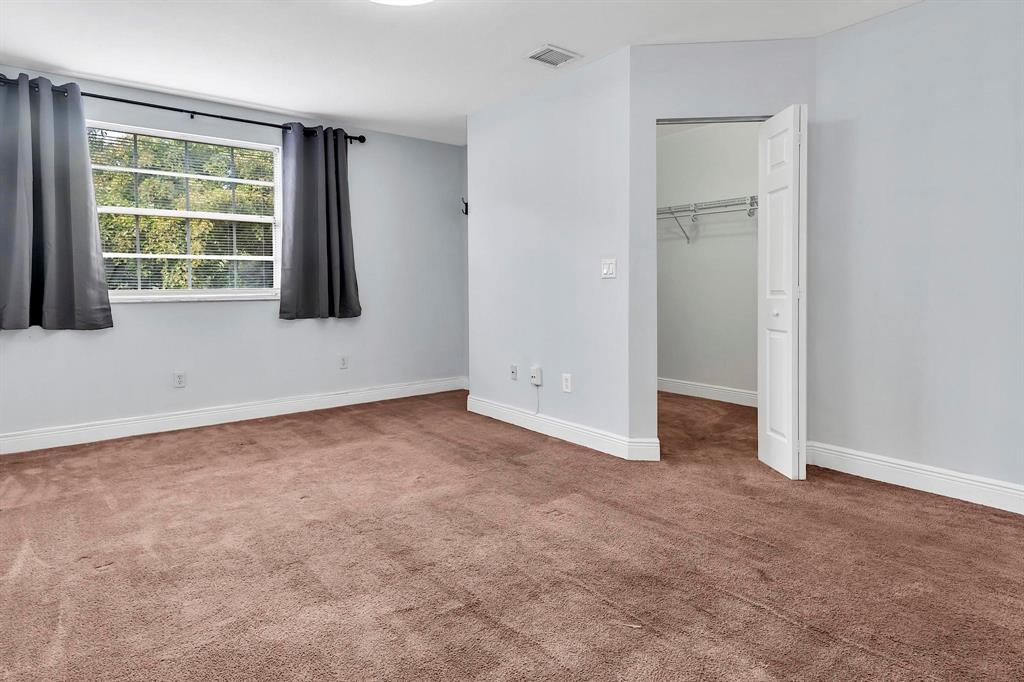 18352 Northwest 68th Avenue, Unit M Hialeah, FL 33015 - Photo 25 of 28 an empty room with windows