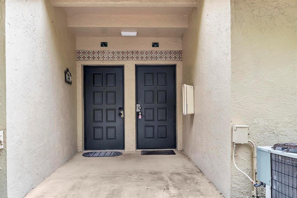 18352 Northwest 68th Avenue, Unit M Hialeah, FL 33015 - Photo 4 of 28 a view of an entrance door of the house