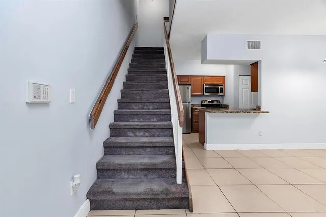 a view of a kitchen with stairs