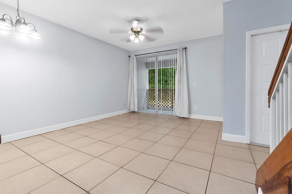18352 Northwest 68th Avenue, Unit M Hialeah, FL 33015 - Photo 8 of 28 a view of an empty room with a window