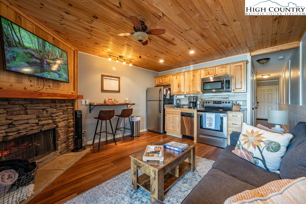 301 Pinnacle Inn Road, Unit 3204B Beech Mountain, NC 28604 - Photo 11 of 33 a living room with furniture and a fireplace