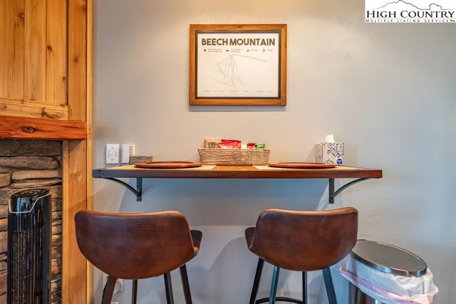 a table and chair with potted plant on wooden floor