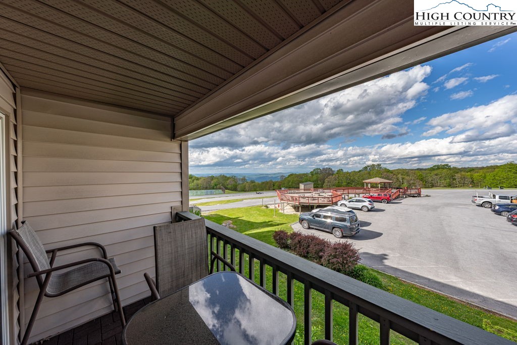 301 Pinnacle Inn Road, Unit 3204B Beech Mountain, NC 28604 - Photo 17 of 33 a view of a balcony with wooden floor and outdoor seating
