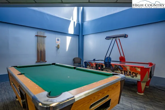 a room with chairs and pool table