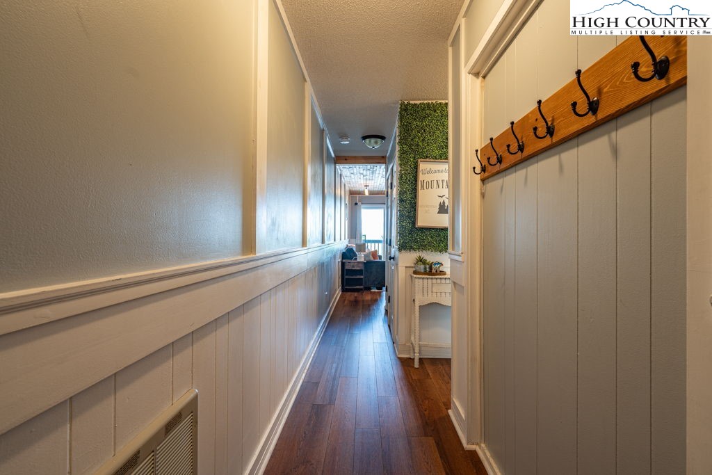 301 Pinnacle Inn Road, Unit 3204B Beech Mountain, NC 28604 - Photo 5 of 33 a view of a hallway with wooden floor and staircase