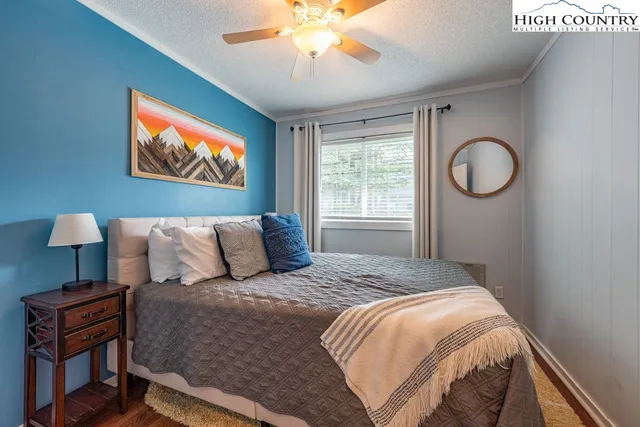 a bed sitting in a bedroom next to a window