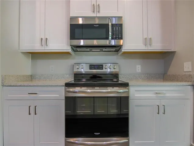 a stove top oven sitting inside of a kitchen