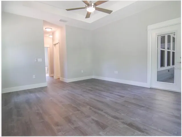 wooden floor in an empty room with a window