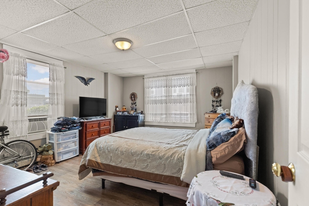 245 Rantoul Street Beverly, MA 01915 - Photo 10 of 12 a bedroom with a bed and a flat tv screen on the dresser