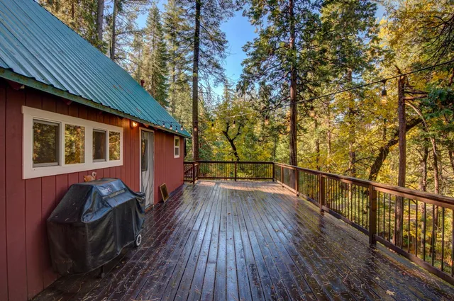 a view of a balcony with wooden floor and fence