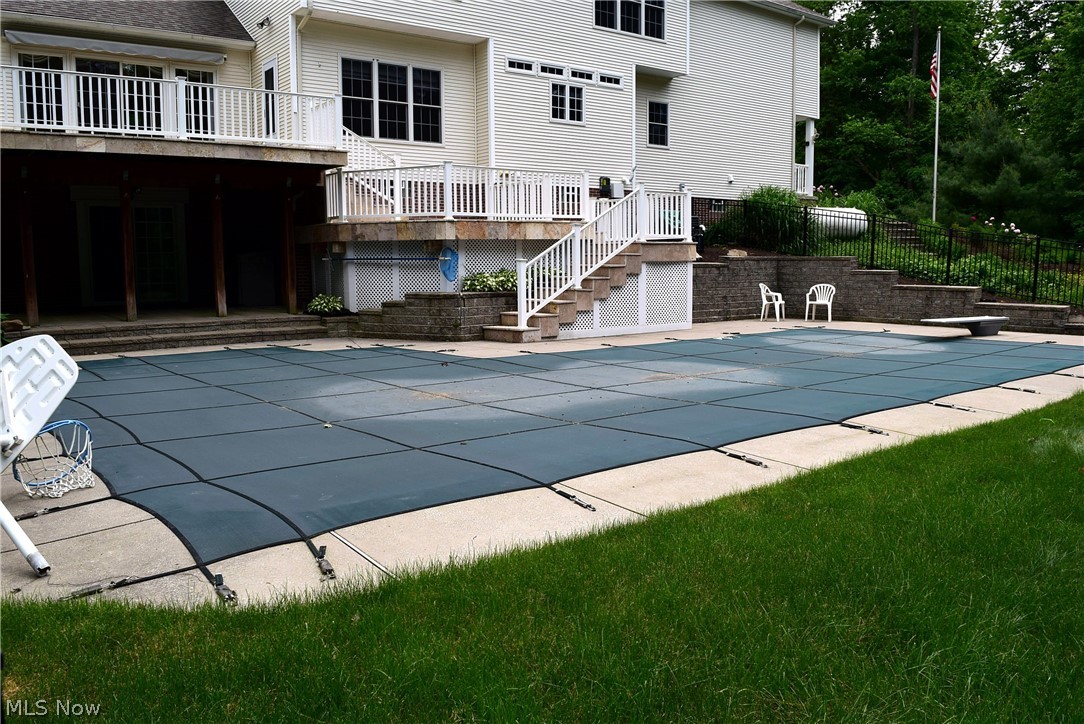 17000 Wing Road Chagrin Falls, OH 44023 - Photo 30 of 35 View of 40' 15' pool towards house with walk-out lower level at left from Rec Room steps and two decks leading to main floor and access from Family room and Kitchen.