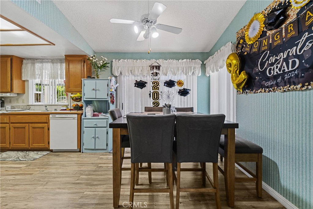 2906 Summer Set Circle Banning, CA 92220 - Photo 11 of 43 a kitchen with a table chairs appliances and cabinets