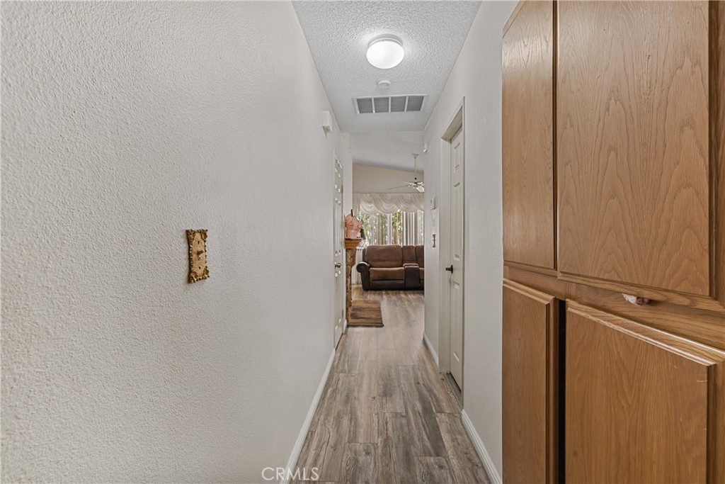 2906 Summer Set Circle Banning, CA 92220 - Photo 17 of 43 a view of a hallway with wooden floor