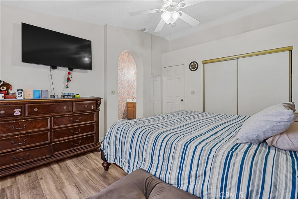 2906 Summer Set Circle Banning, CA 92220 - Photo 23 of 43 a bedroom with a bed and a flat screen tv