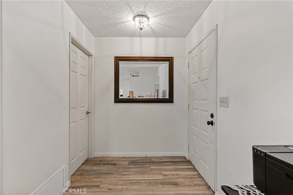 2906 Summer Set Circle Banning, CA 92220 - Photo 6 of 43 a view of an empty room with closet and wooden floor