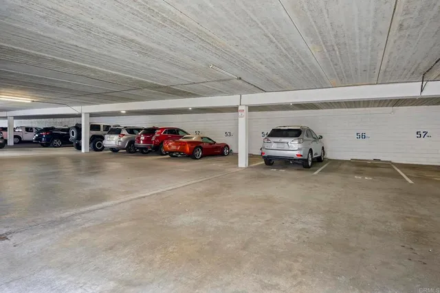a view of a porch with couches and chairs under an umbrella