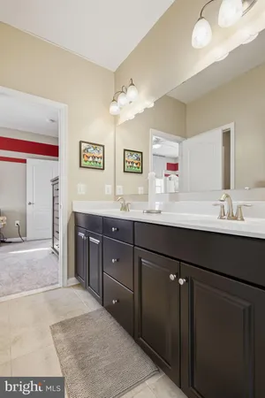 a kitchen with granite countertop a refrigerator and a stove top oven
