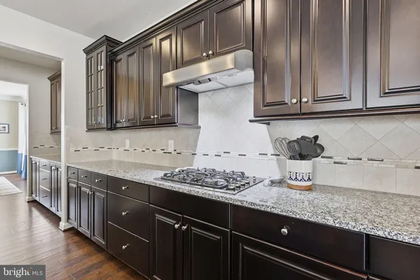 a kitchen with granite countertop stainless steel appliances a sink and cabinets